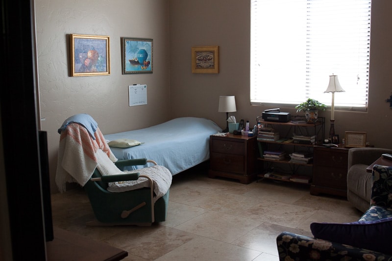 A shower featuring a shower chair and a curtain